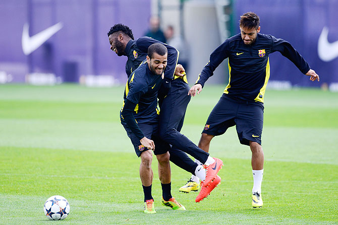 Barcelona's Dani Alves, Alex Song and Neymar go through the grind during a training session at Sant Joan Despi Sport Complex in Barcelona on Monday