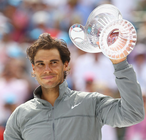 Rafael Nadal of Spain holds the runners-up trophy after losing to Novak Djokovic of Serbia in the final in Miami