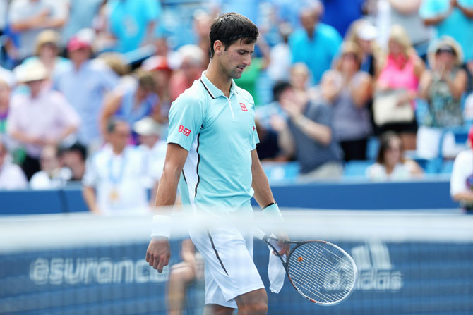 Novak Djokovic of Serbia walks off the court after a defeat