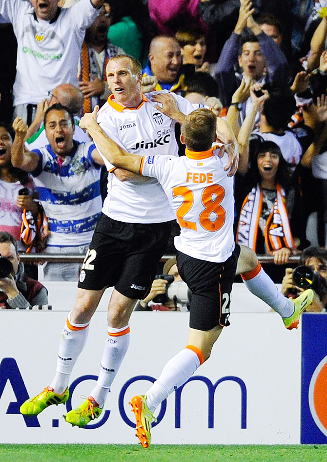 Jeremy Mathieu (left) of Valencia celebrates with teammates after scoring against Sevilla on Thursday