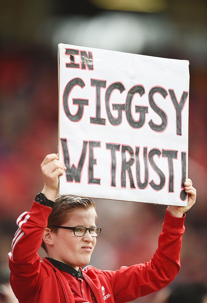 A young fan shows his approval of the appointment of Ryan Giggs during the Barclays Premier League match between Manchester United and Norwich City at Old Trafford