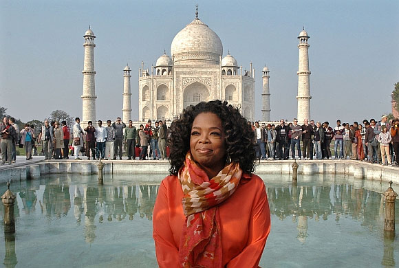 Oprah Winfrey poses for pictures in front of the historic Taj Mahal during her visit to Agra