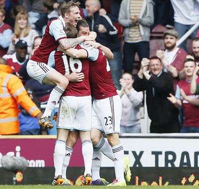 Stewart Downing (right) of West Ham United is mobbed by teammates after scoring against Tottenham Hotspur during their English Premier League match at Upton Park in London on Saturday