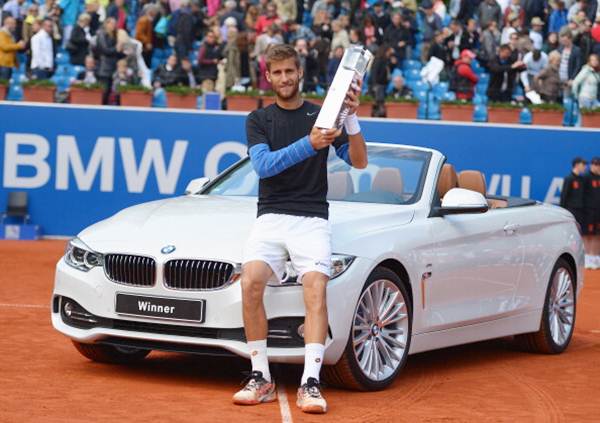Martin Klizan of Slovakia poses with the trophy after winning the BMW Open final against Fabio Fognini of Italy in Munich, Germany