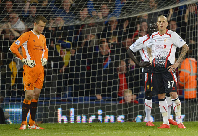 Liverpool players react after Crystal Palace score an equalising goal
