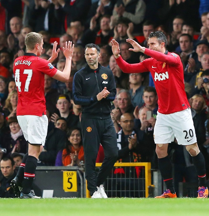 Manchester United Caretaker Manager Ryan Giggs looks on as James Wilson is substituted for Robin van Persie
