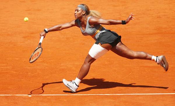Serena Williams of the United States stretches to play a forehand against Carla Suarez Navarro of Spain in their third round of the Madrid Open.