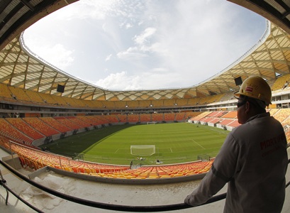A construction worker looks out over the stadium 