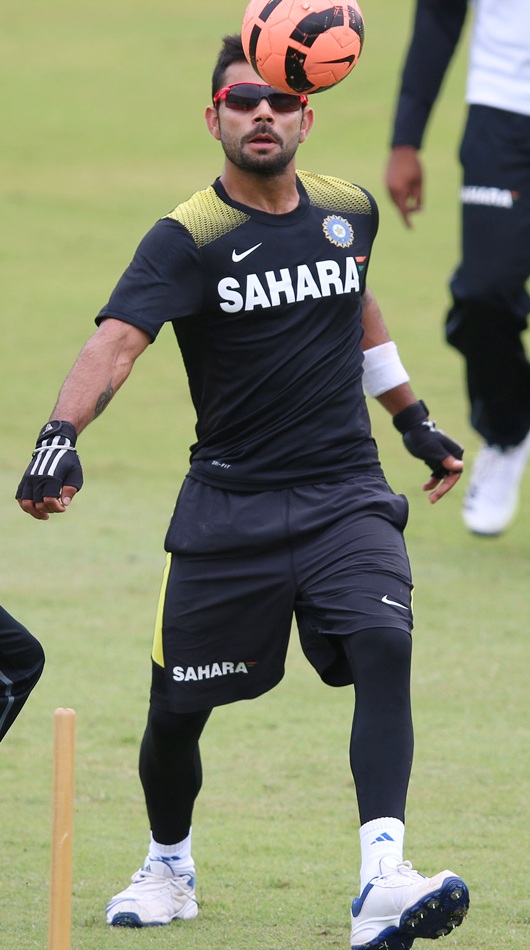Virat Kohli of India plays football