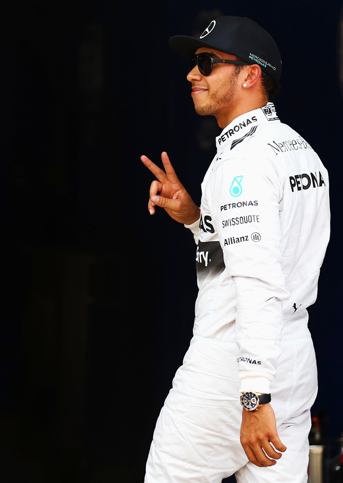 Lewis Hamilton of Great Britain and Mercedes GP celebrates after securing Pole Position