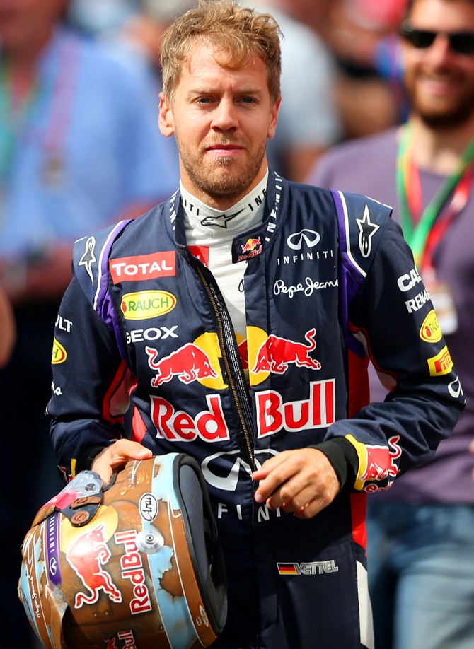 Sebastian Vettel of Germany and Infiniti Red Bull Racing runs to the garage