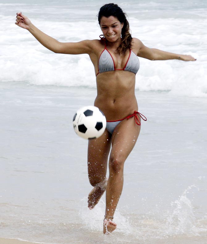 A woman plays soccer on Ipanema beach in Rio de Janeiro