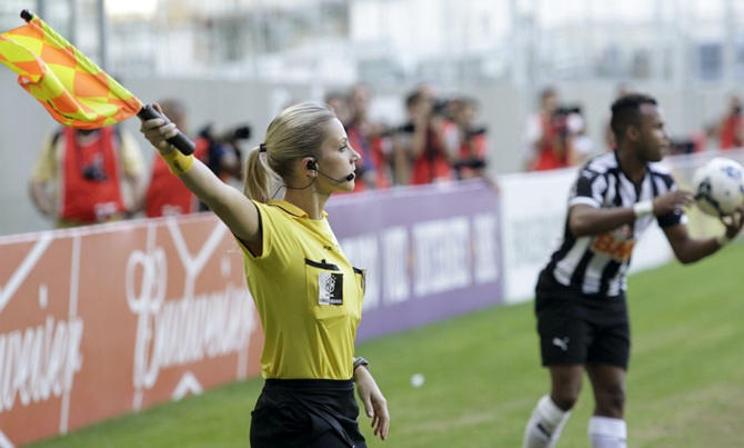 Brazil's referee assistant Fernanda Colombo Uliana signals a throw-in next to Atletico Mineiro's Fernandinho.