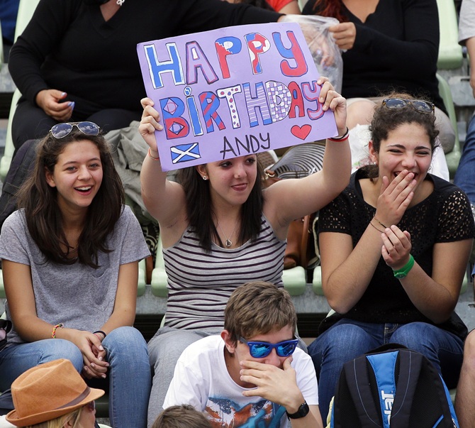 A fan of Andy Murray of Britain holds a banner wishing him 'Happy birthday'
