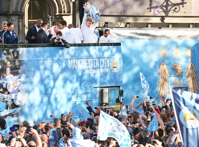 Joe Hart of Manchester City lifts the Barclays Premier League trophy aloft