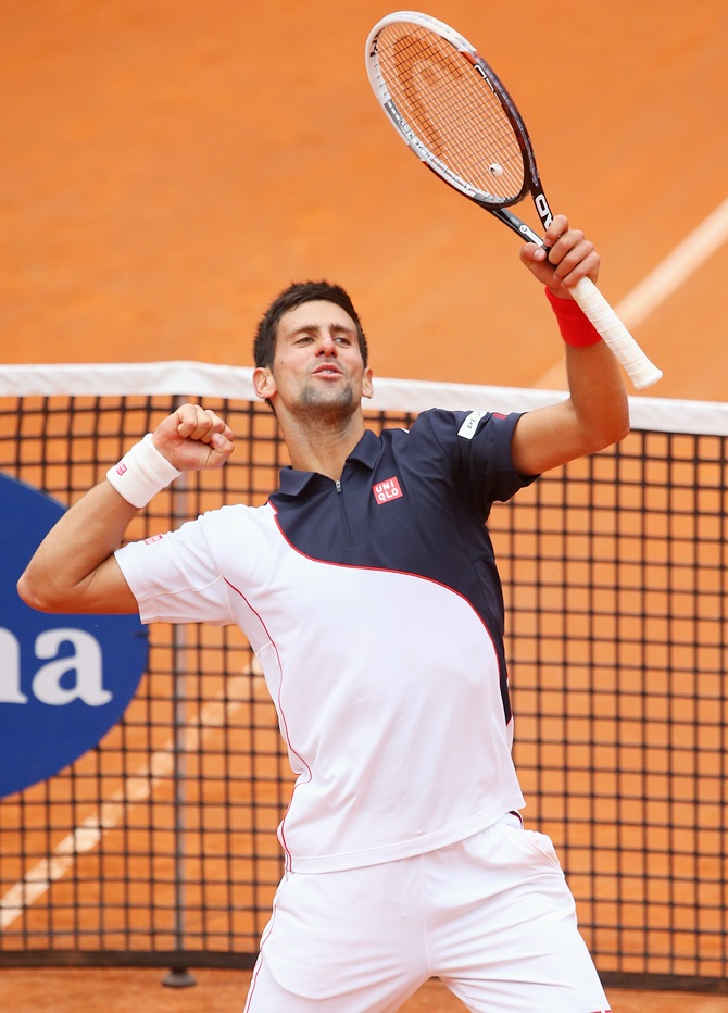 Novak Djokovic of Serbia celebrates defeating David Ferrer