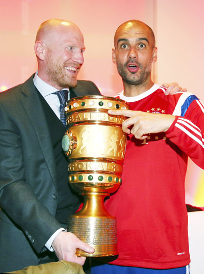 Bayern Munich's coach Pep Guardiola (right) and sports director Matthias Sammer pose with the German DFB Cup