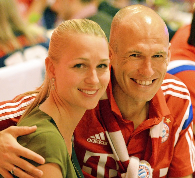 Bayern Munich's Arjen Robben and his wife Bernadien pose at the after-match party