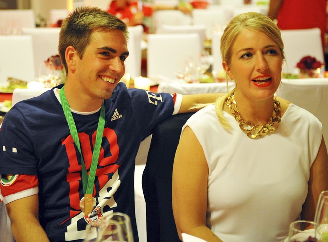 Bayern Munich's Philipp Lahm and his wife Claudia attend the team's after-match party