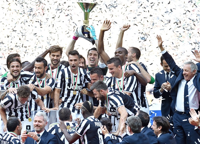 The Juventus FC players celebrate with the Serie A trophy