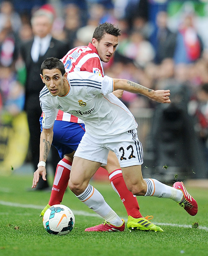 Angel Di Maria (#22) of Real Madrid CF challenges Koke of Club Atletico de Madrid during the La Liga match