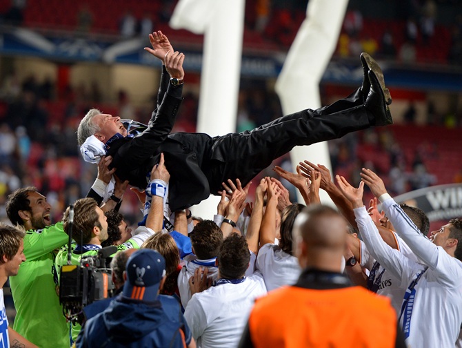 Head Coach, Carlo Ancelotti of Real Madrid is lifted in celebration by his players