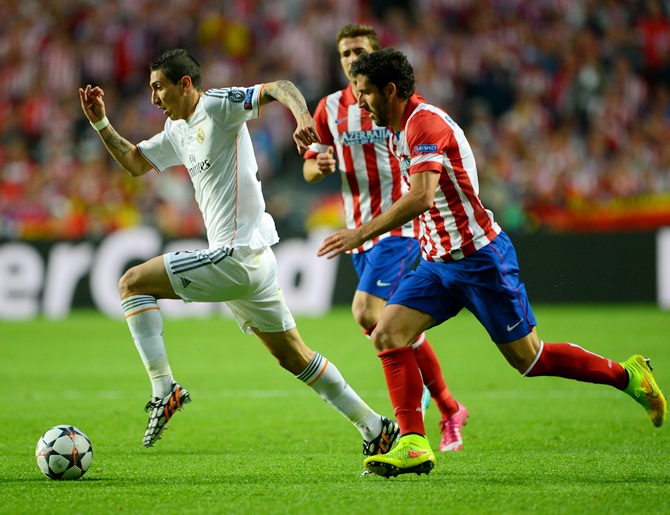Angel Di Maria of Real Madrid breaks away from Raul Garcia of Club Atletico de Madrid