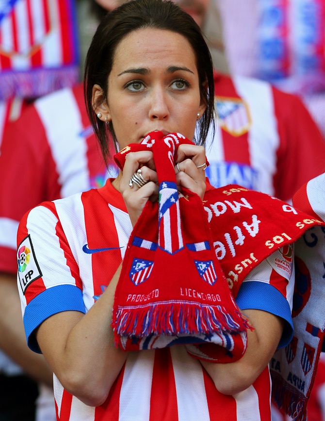 An Atletico de Madrid fan shows her colours
