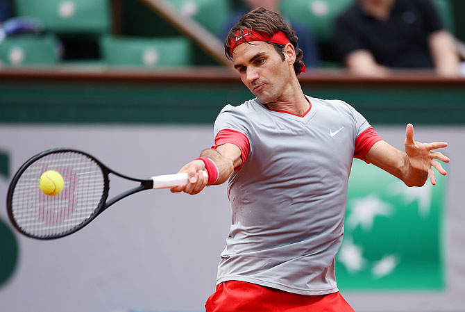 Roger Federer of Switzerland returns a shot against Lukas Lacko of Slovakia during their men's singles match on Sunday