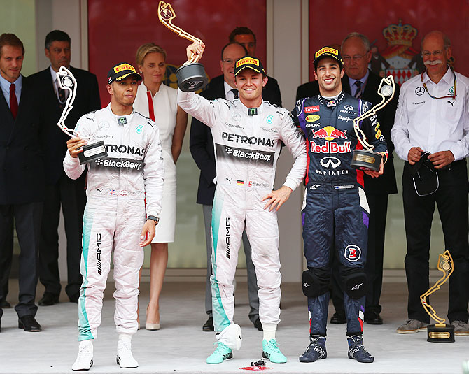 Lewis Hamilton (2nd place) of Great Britain and Mercedes GP, Nico Rosberg (1st place) of Germany and Mercedes GP and Daniel Ricciardo (3rd place) of Australia and Infiniti Red Bull Racing pose on the podium following the Monaco Formula One Grand Prix at Circuit de Monaco on Sunday