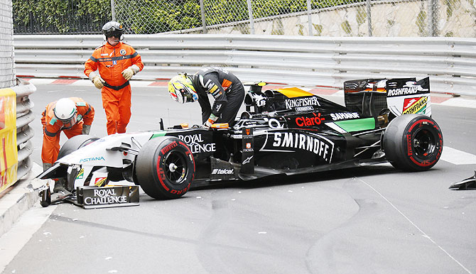Force India Formula One driver Sergio Perez leaves his car after crashing at the start of the Monaco F1 Grand Prix in Monaco on Sunday