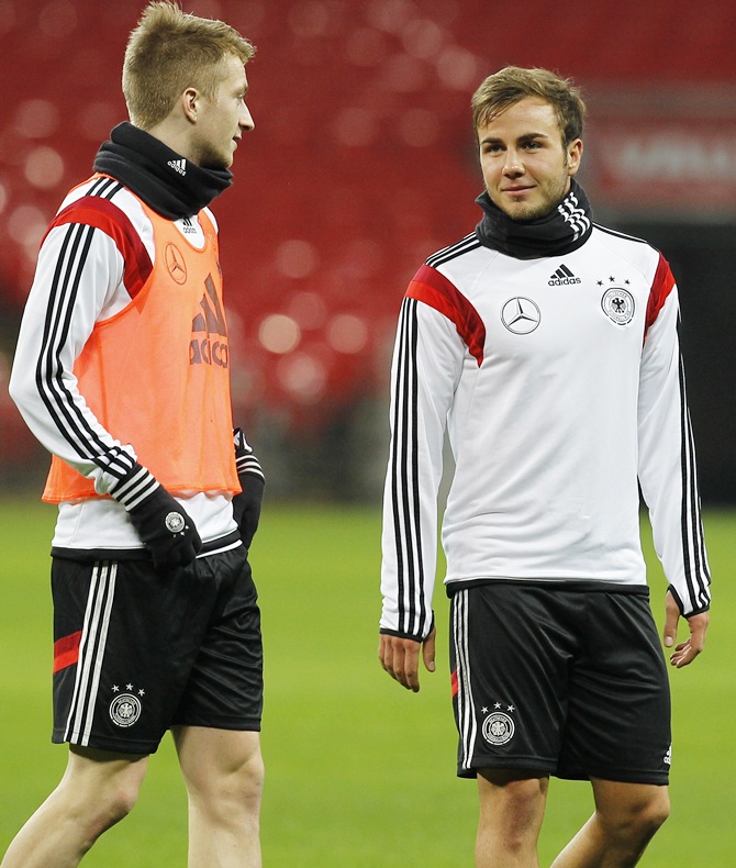 Marco Reus and Mario Goetze of Germany warm up during a training session