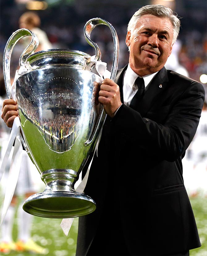 Real Madrid's coach Carlo Ancelotti poses with  the Champions League trophy