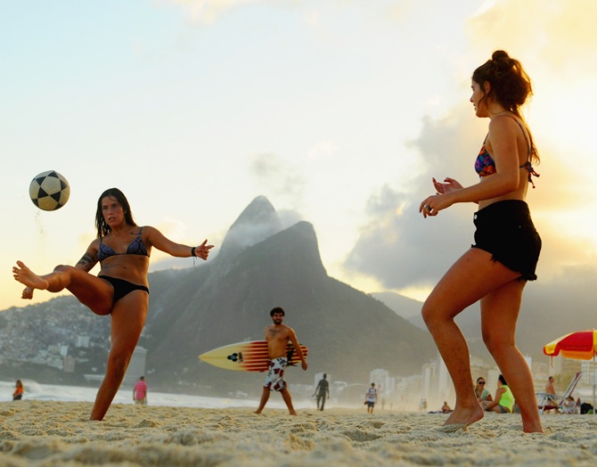 Women play football on Ipanema beach.
