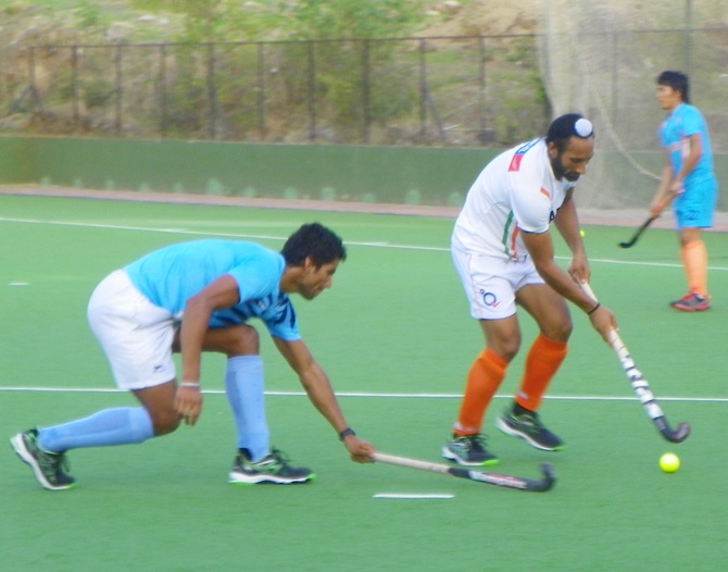 Rupinderpal Singh (in blue) and Sardar Singh practice a penalty-corner drill