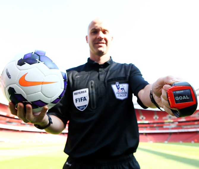 Referee Anthony Taylor tests the technology during the Goal Decision System (GDS) media event