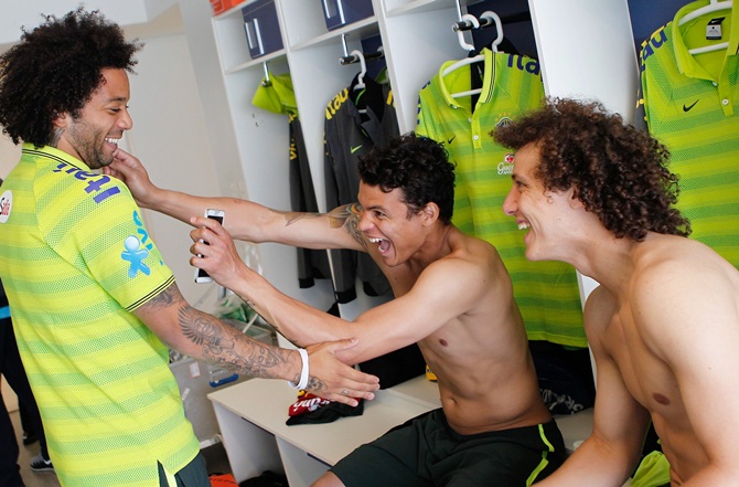 From left, Brazilian national football team players Marcelo, Thiago Silva and David Luiz joke at the squad's Granja Comary training complex, in Teresopolis, 90 km from downtown Rio de Janeiro