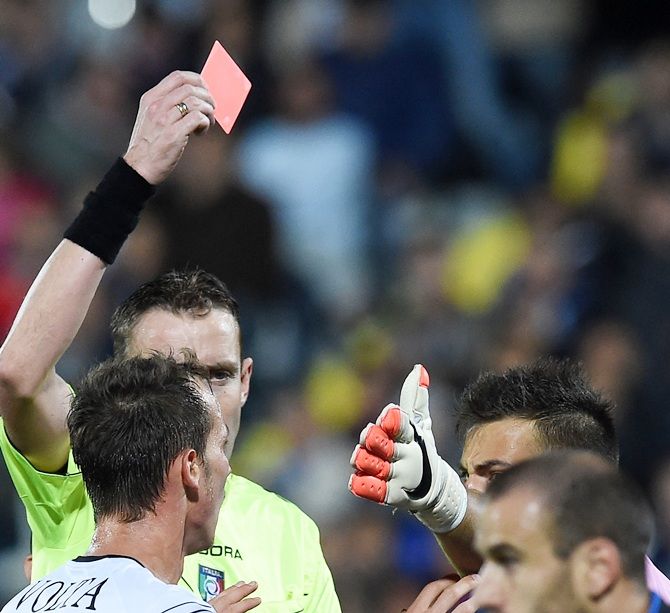 Referee Paolo Silvio Mazzoleni shows the red card