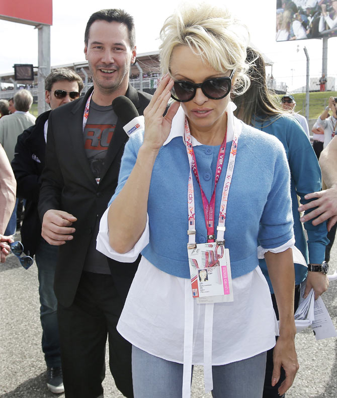 Pamela Anderson and Keanu Reeves arrive for the US Open Grand Prix on Sunday