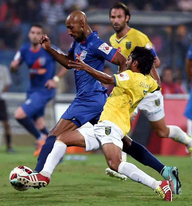 Mumbai City FC's Nicolas Anelka dribbles the ball past Kerala Blasters defenders