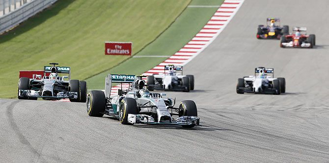 Mercedes Formula One driver Nico Rosberg of Germany leads teammate Lewis Hamilton of Britain (L) during the F1 United States Grand Prix
