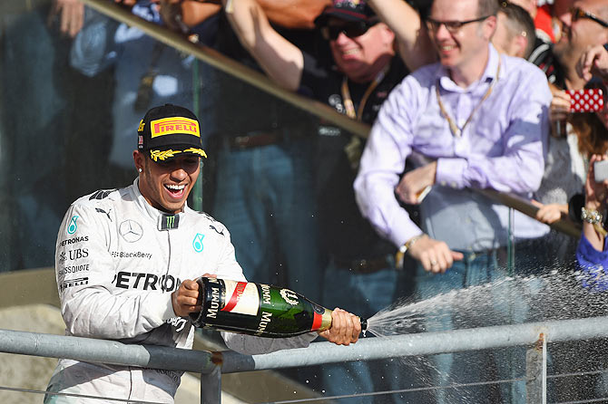 Lewis Hamilton of Great Britain and Mercedes GP celebrates on the podium following his victory in the United States Formula One Grand Prix at Circuit of The Americas in Austin, Texas, on Sunday