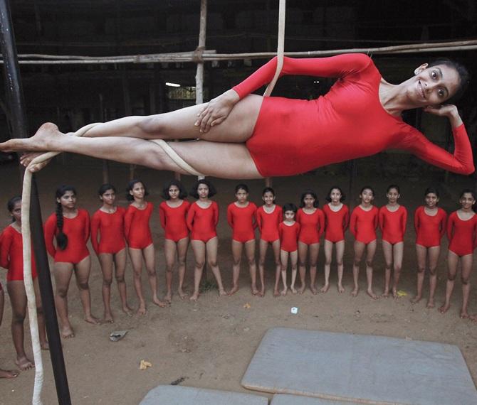 A girl practises a Mallakhamb