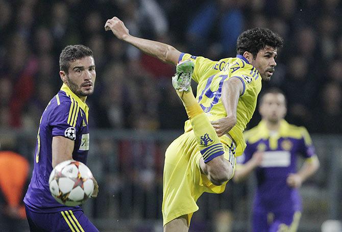 Maribor's Aleksander Rajcevic (left) challenges Chelsea's Diego Costa during their Champions League Group G match at stadium Ljudski vrt in Maribor on Wednesday