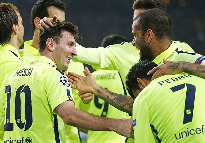 Barcelona's Lionel Messi (L) celebrates his goal with teammates during their Champions League Group F soccer match against Ajax at Amsterdam Arena stadium