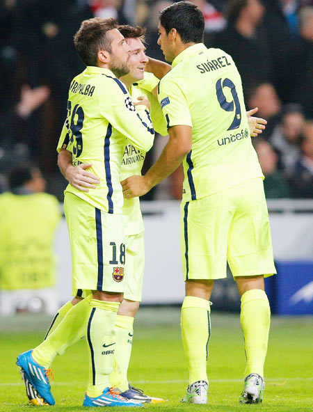 Lionel Messi of Barcelona celebrates scoring the opening goal with Luis Suarez and Jordi Alba of Barcelona during the UEFA Champions League Group F match against AFC Ajax