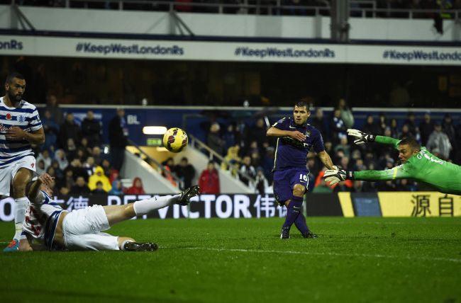 Manchester City's Sergio Aguero shoots to score past Queens Park Rangers' goalkeeper Robert Green (R) during their English Premier League match