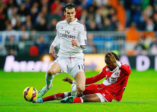 Gareth Bale of Real Madrid CF is challenged by Abdoulaye Ba of Rayo Vallecano during their La Liga match on Saturday