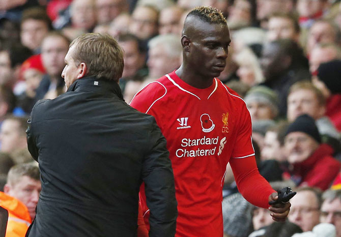 Liverpool's Mario Balotelli (right) leaves the pitch after being substituted by manager Brendan Rodgers on Saturday