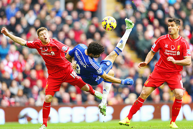 Diego Costa of Chelsea attempts an overhead kick during a challenge from Alberto Moreno of Liverpool on Saturday